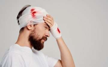 man with a bandage on injured head