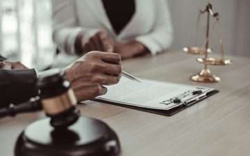people a desk with gavel and pad on the desk