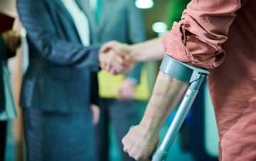 injured man shaking lawyer hand