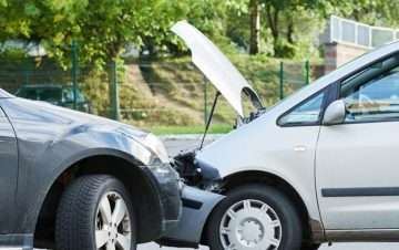 White car and gray car in head-on collision.