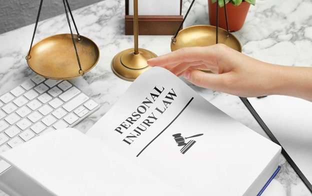 Person at desk looking at document that says "personal injury law."